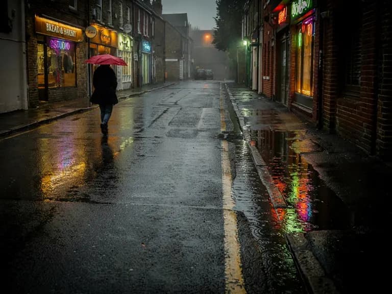 Ideogram 3.0's image for “A rainy street at night, one red umbrella”